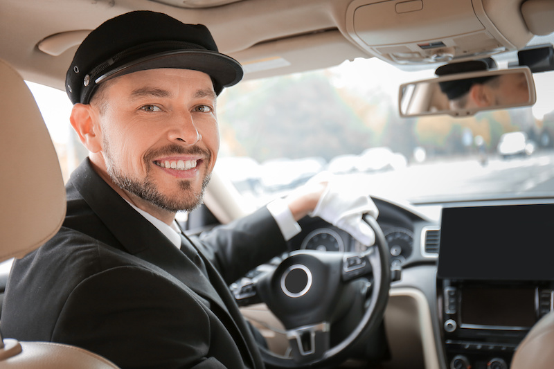 Chauffeur smiling driving limo