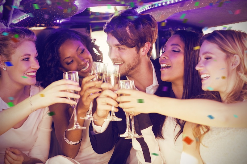 Group of people celebrating in limo