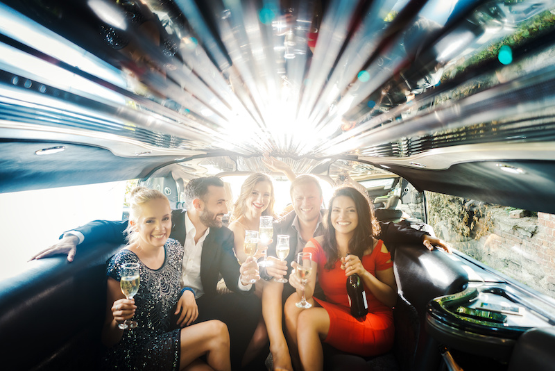 Group of people having fun in a limo